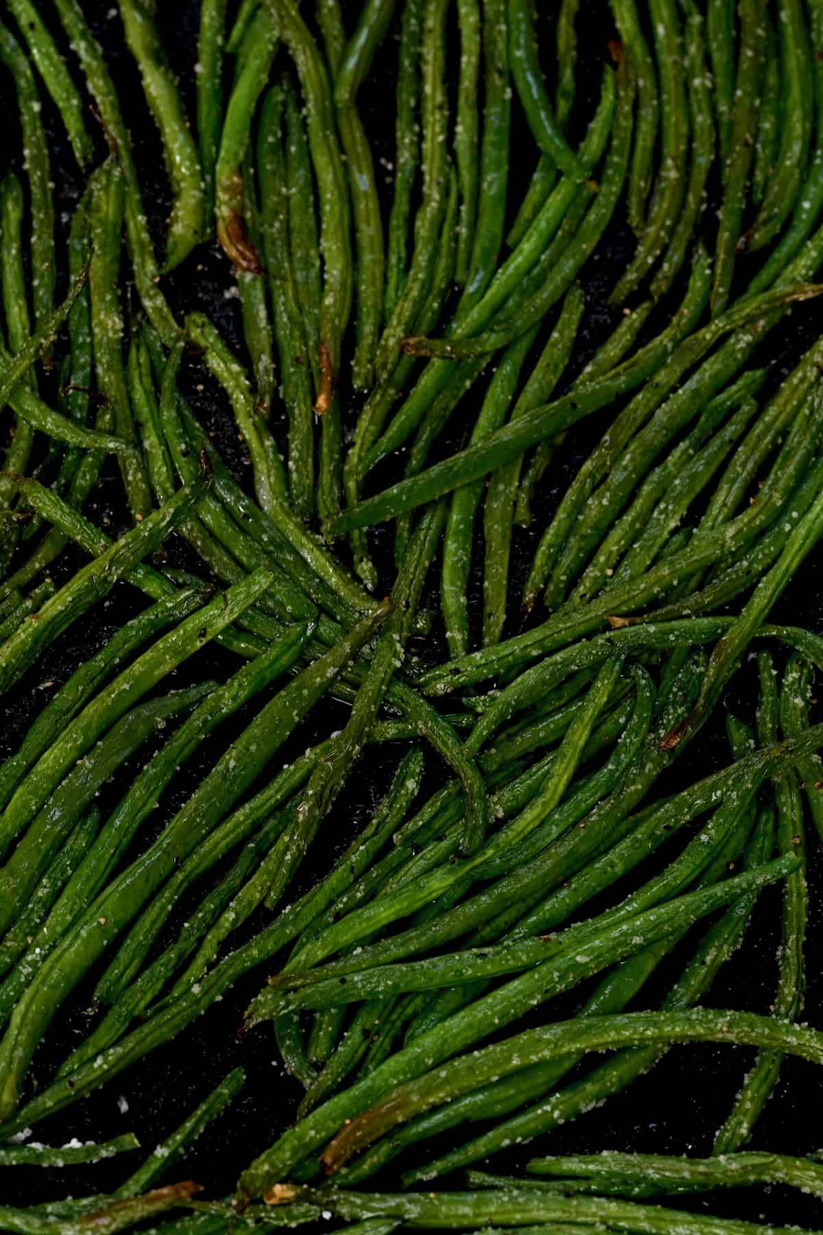 A close up of roasted green beans