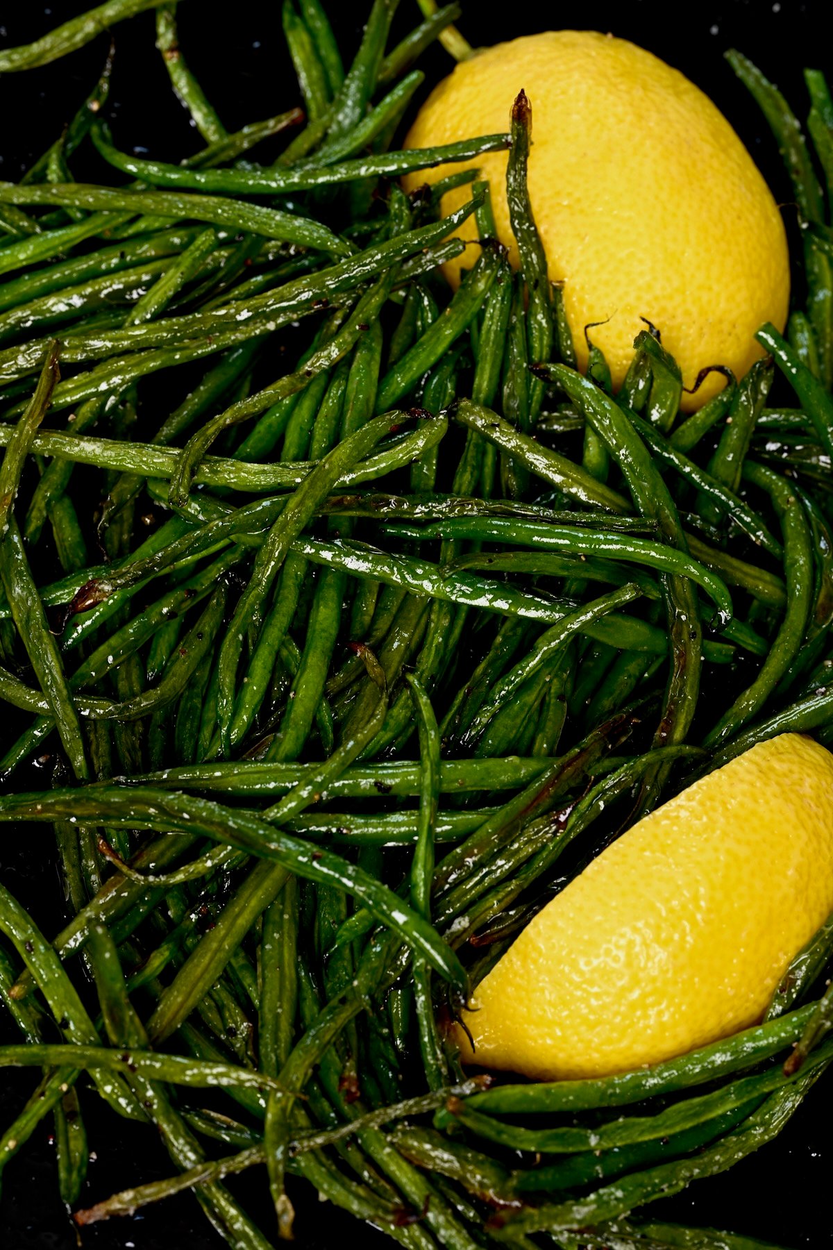 Lemon wedges and roasted green beans