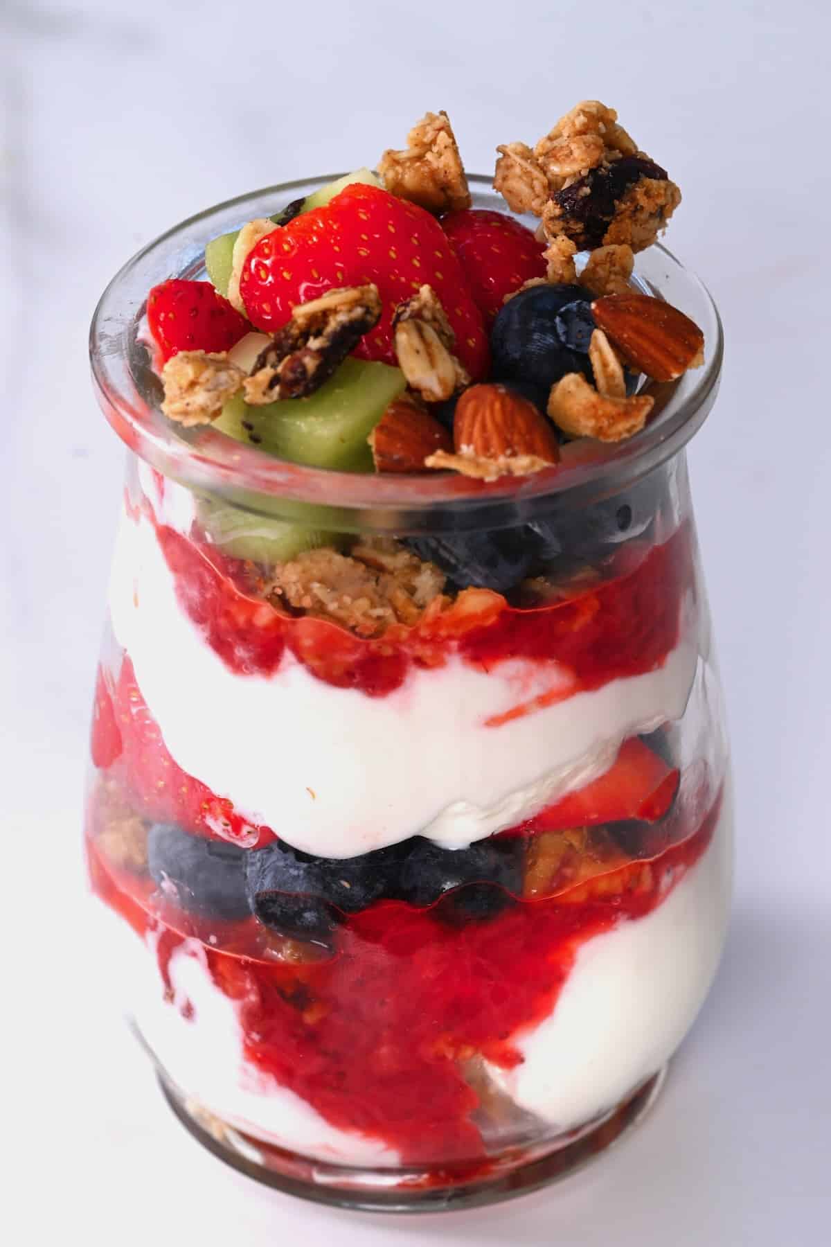 A small glass cup with yogurt parfait