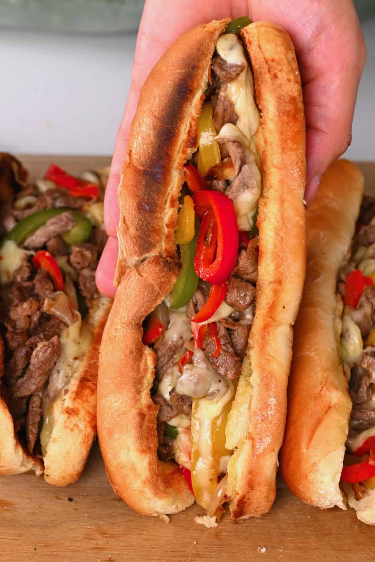 A philly cheesesteak sandwich with bell peppers