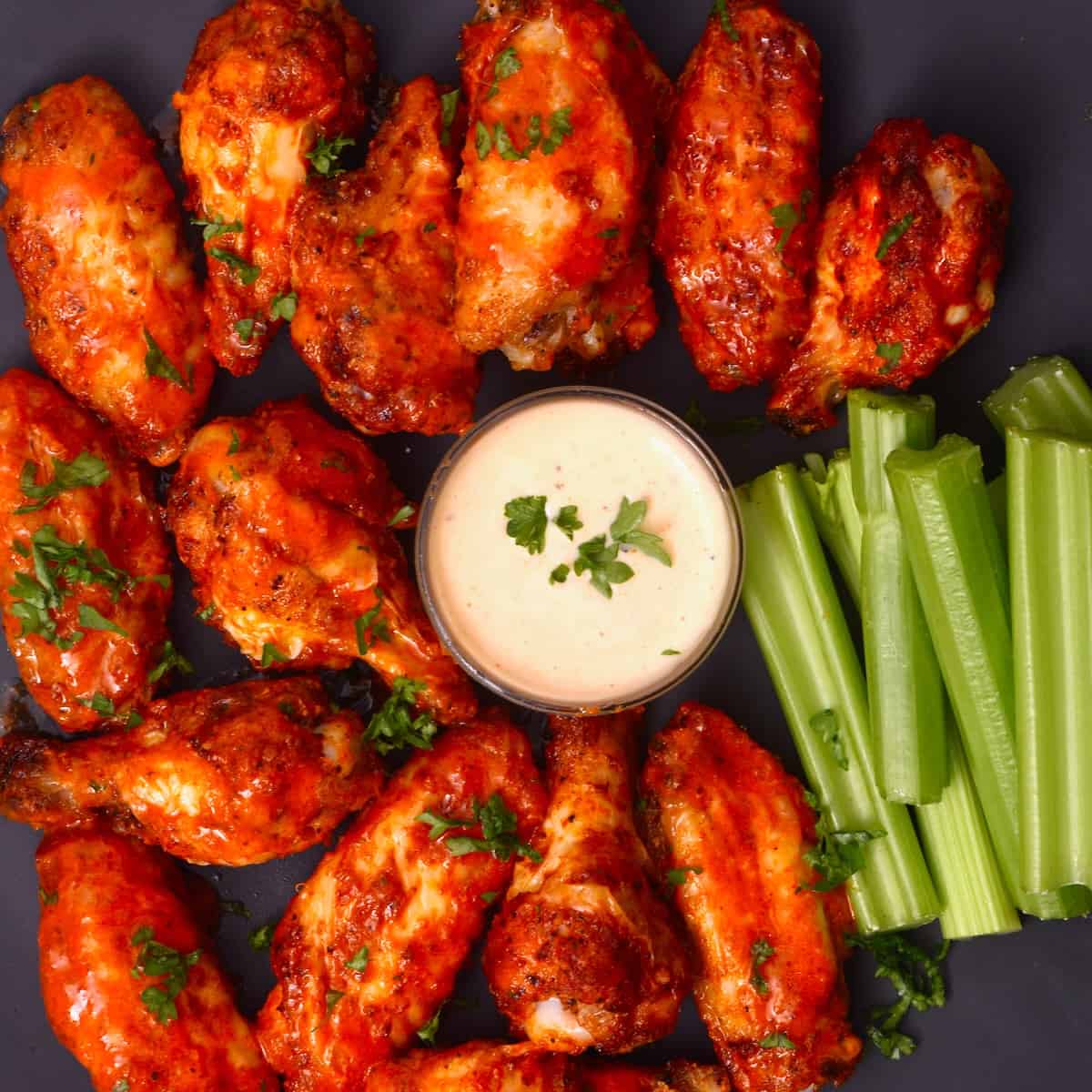 Air fryer buffalo chicken wings with dipping sauce and celery sticks
