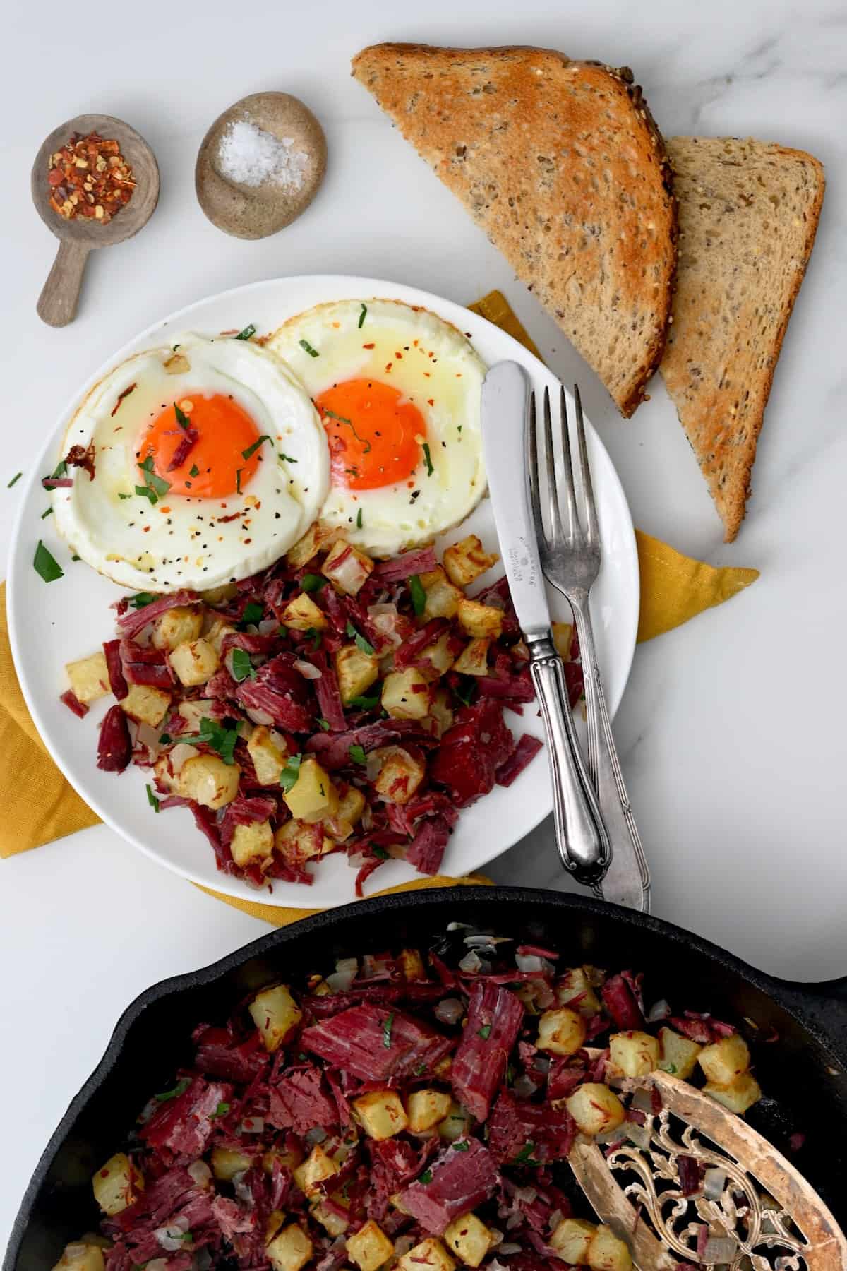A serving with beef hash and fried eggs