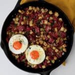 A pan with corned beef hash and two fried eggs