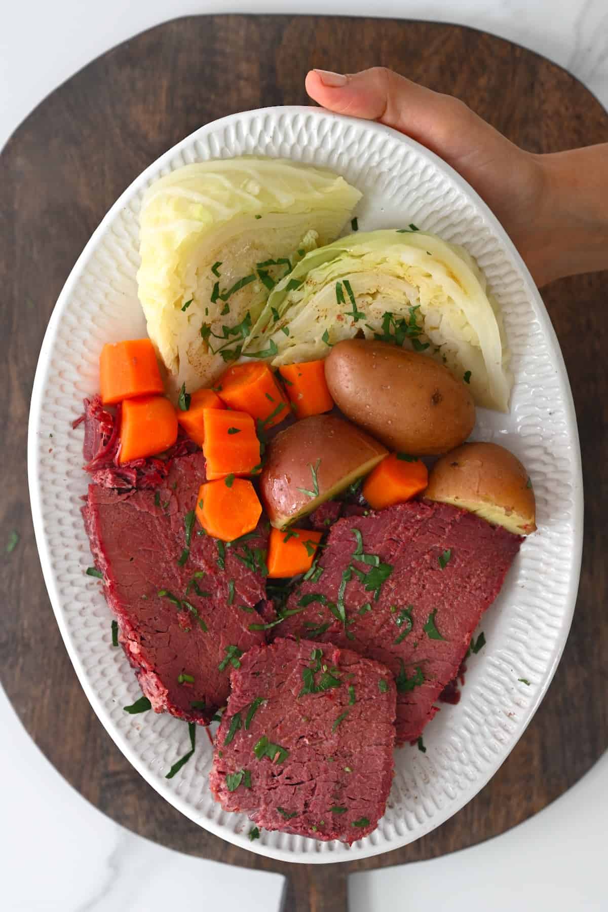 Corned beef and cabbage on a plate with potatoes and carrots