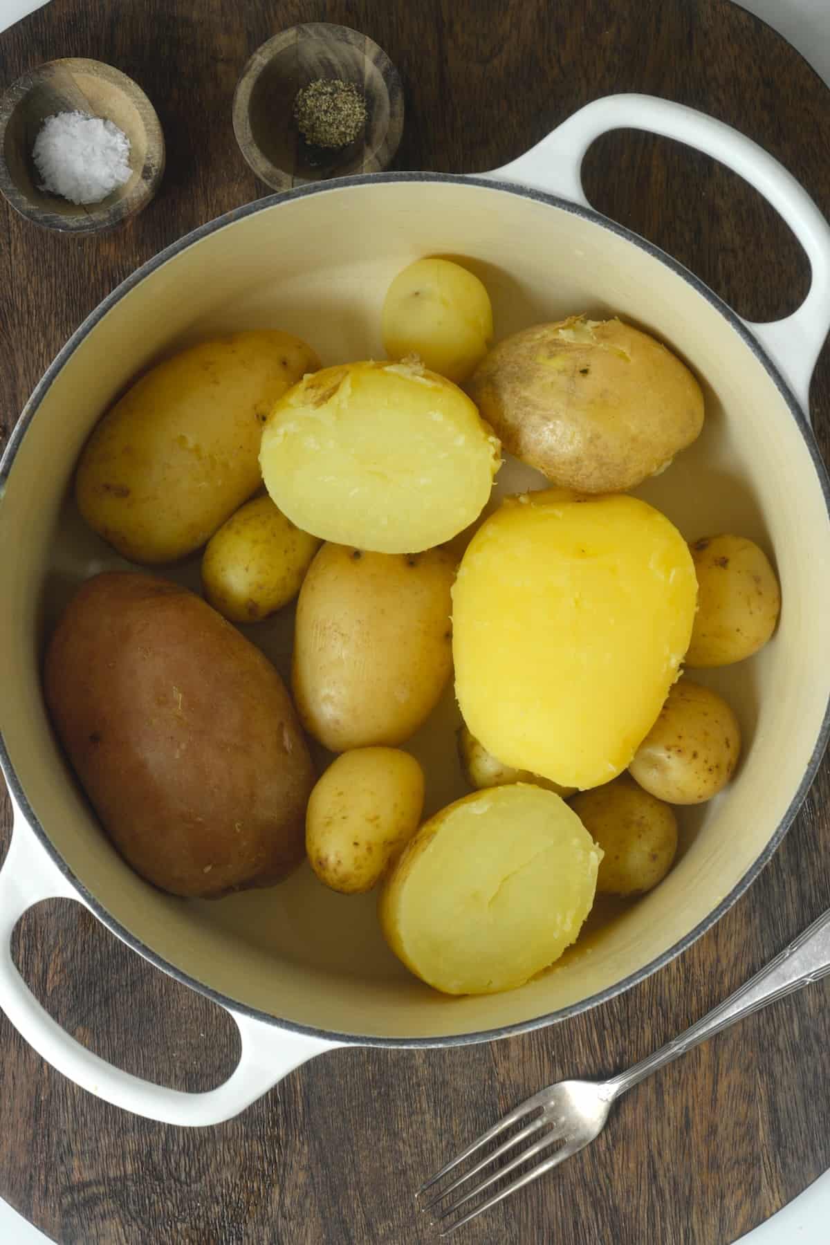 Boiled whole and halved potatoes in a pot