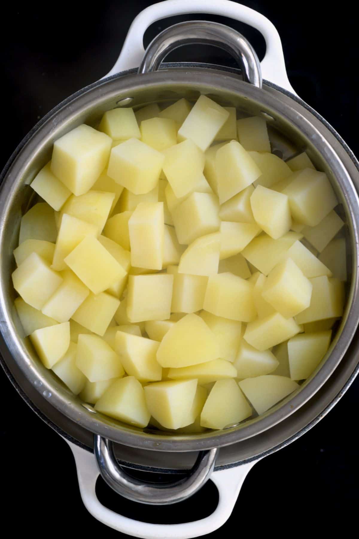 Cubed boiled potatoes in a colander