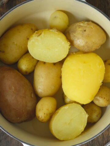 Boiled whole and halved potatoes in a pot