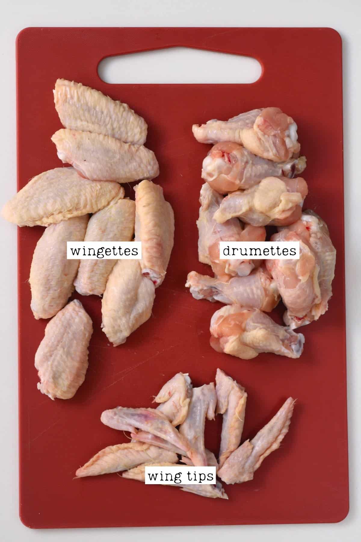Chicken wings cut into parts on a chopping board