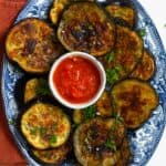 Roasted eggplant slices and tomato sauce on a plate - 14