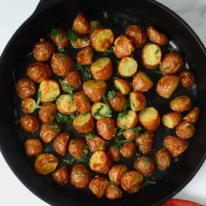 Oven-roasted new red potatoes in a skillet