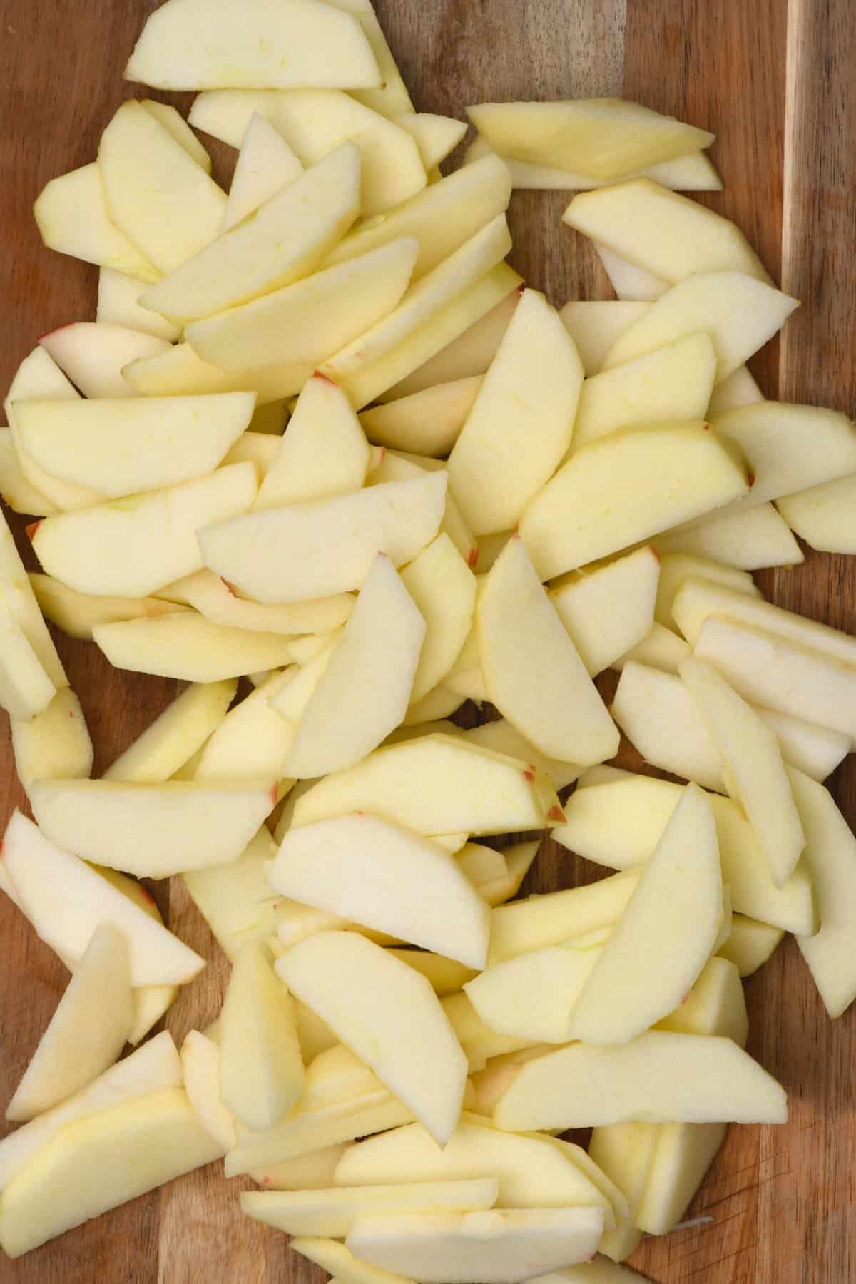 Thinly sliced apples on a chopping board