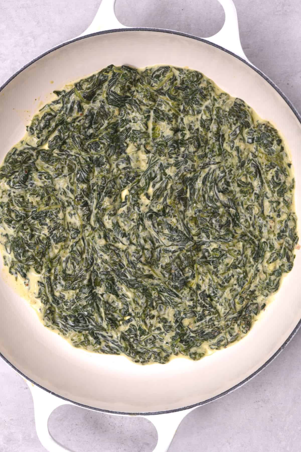Freshly cooked creamed spinach in a saucepan