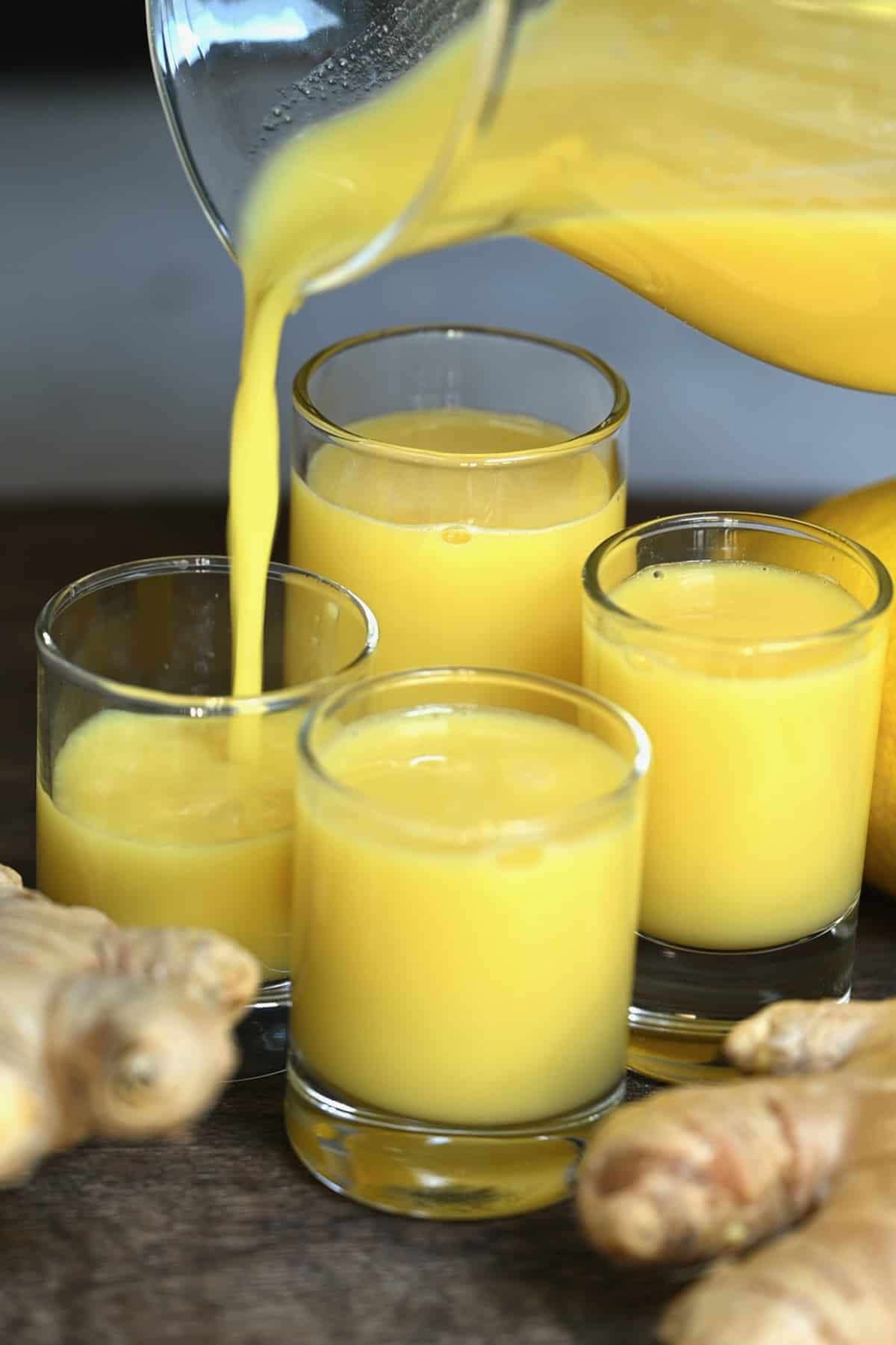 Pouring ginger shots in small glasses