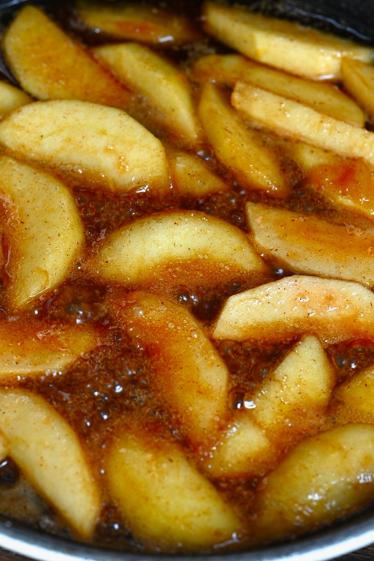 A close up of fried apples in a pan
