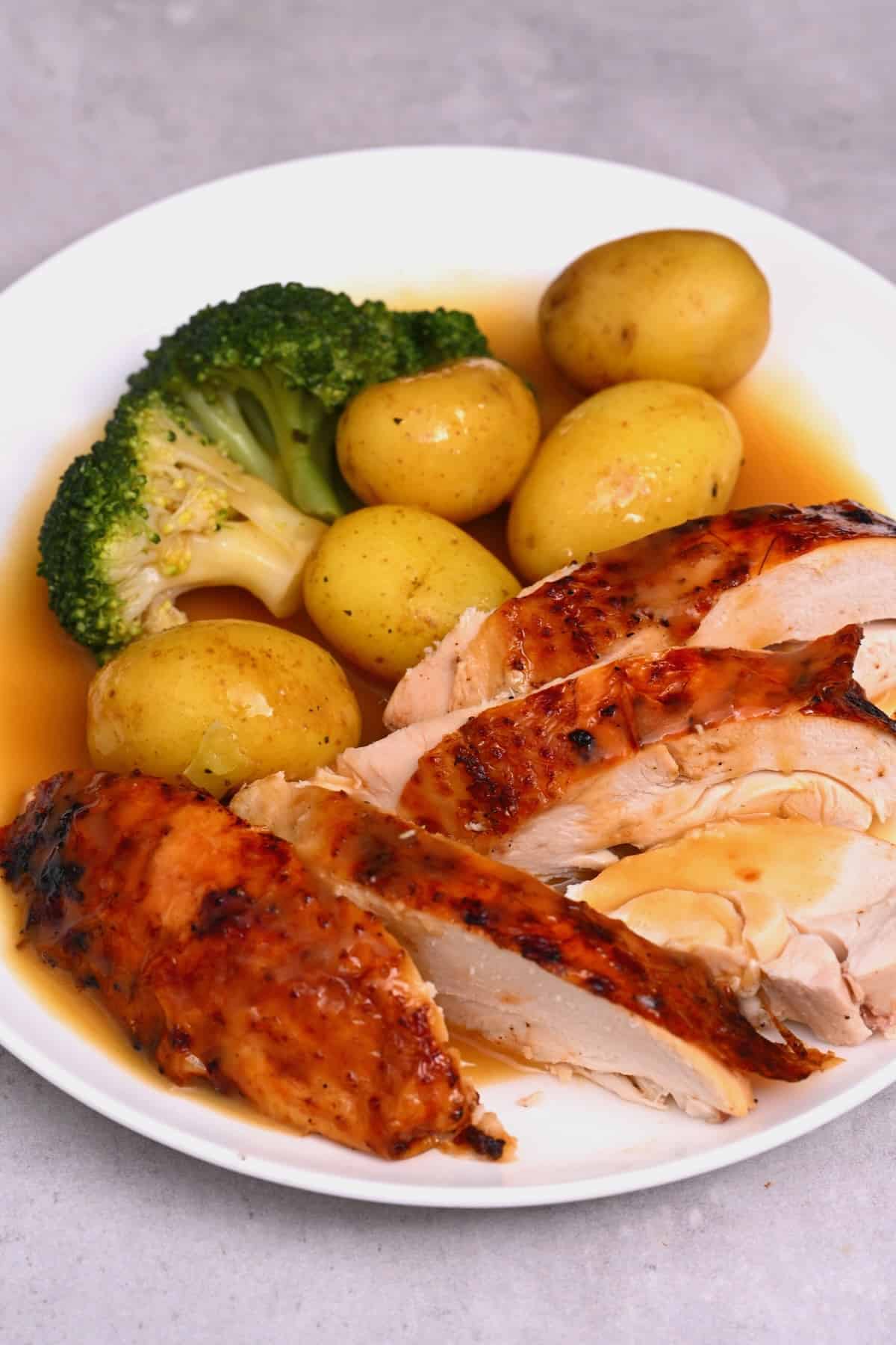 A portion of brined chicken with vegetables