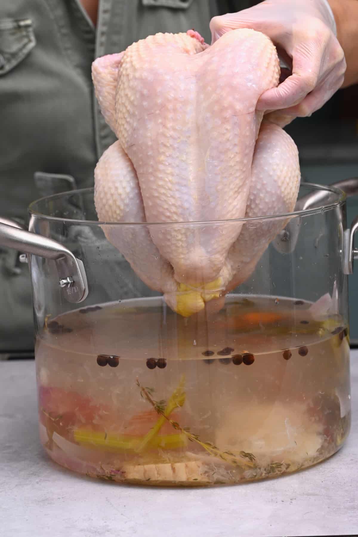 Placing a whole chicken in brine