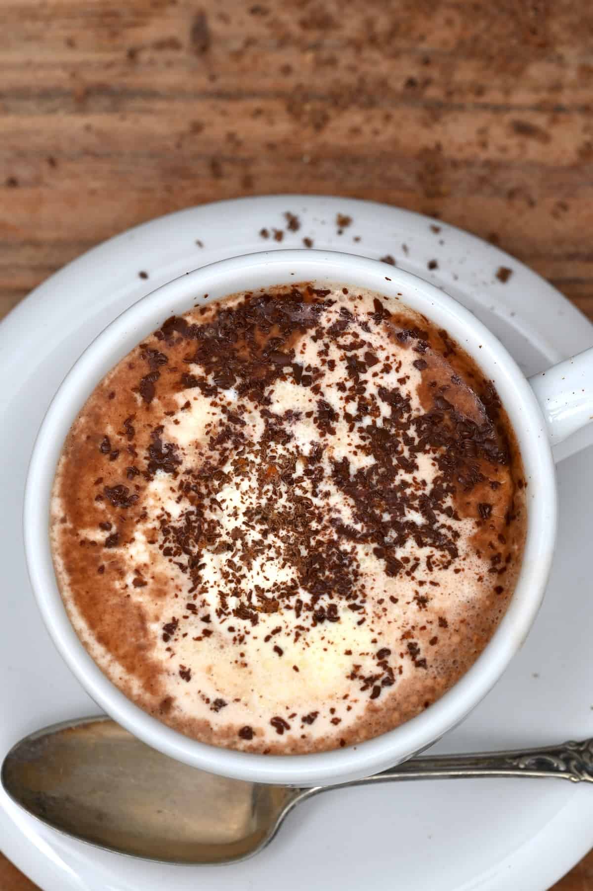 A cup of hot cocoa topped with chocolate shavings