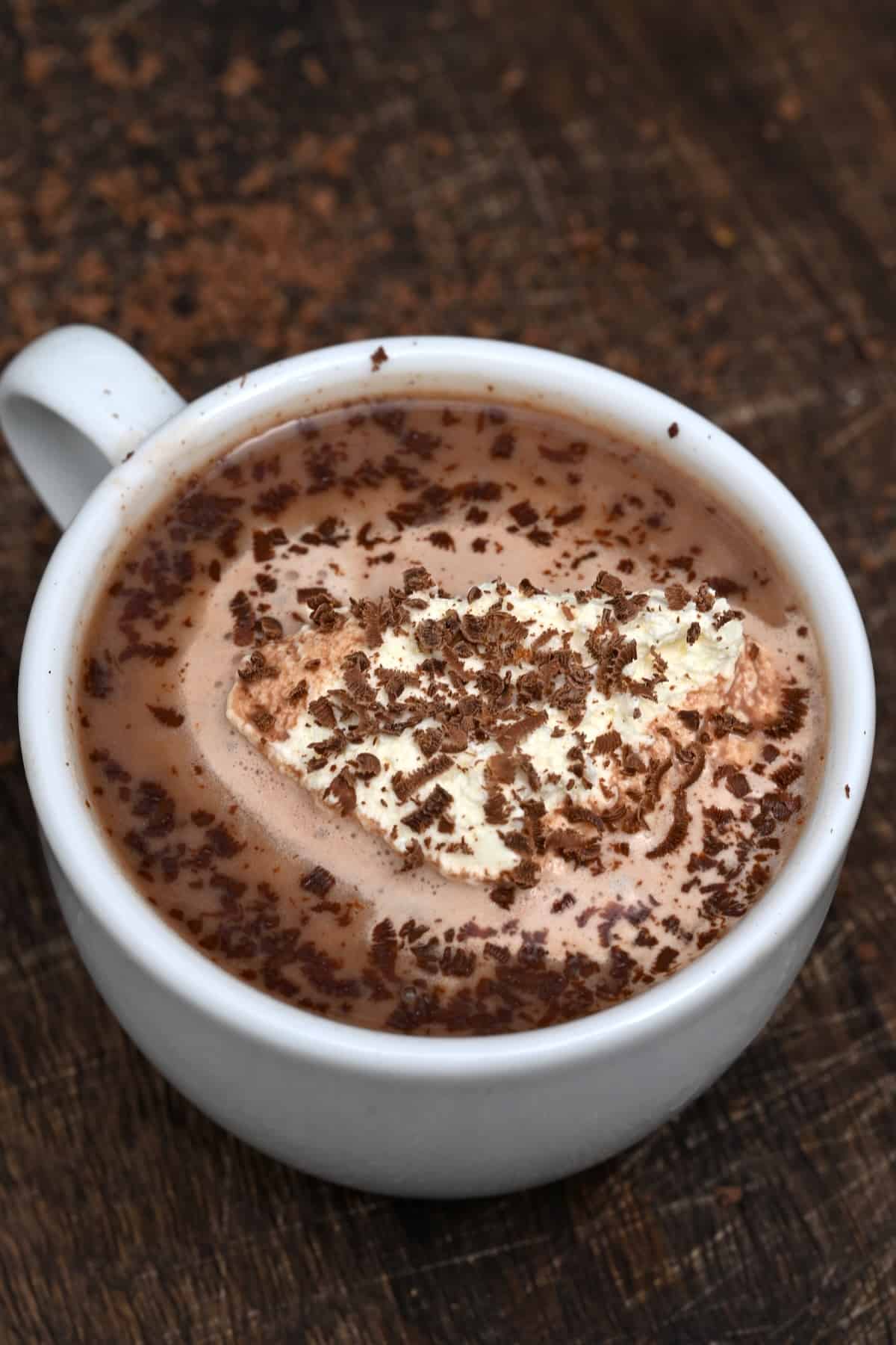 Homemade hot chocolate with whipped cream and chocolate shavings