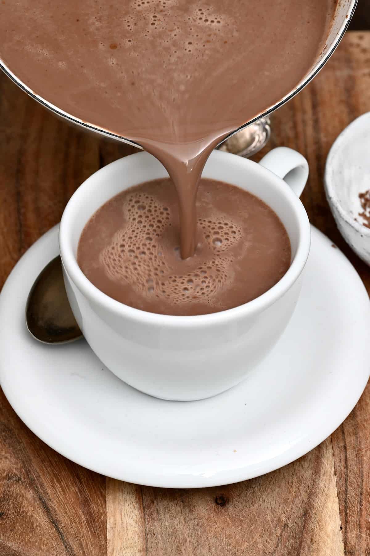 Pouring hot cocoa in a cup