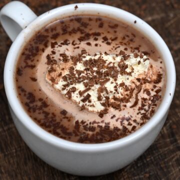 Homemade hot chocolate with whipped cream and chocolate shavings