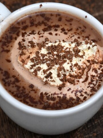 Homemade hot chocolate with whipped cream and chocolate shavings