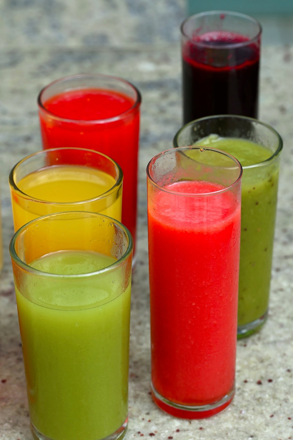 Six glasses with homemade fresh fruit and veggie juices