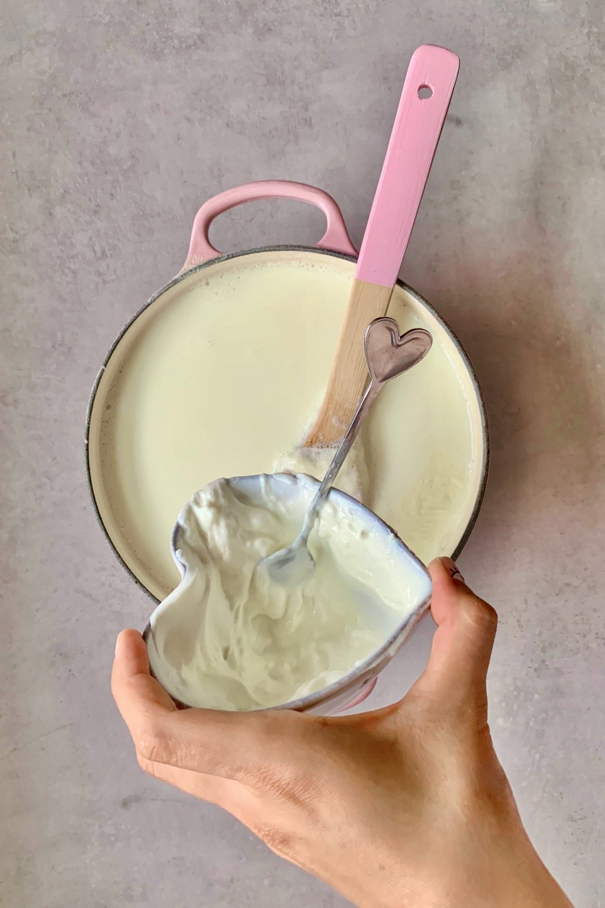 Mixing yogurt starter into milk
