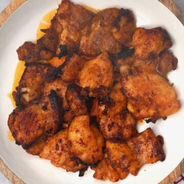 Oven baked boneless chicken thighs on a plate