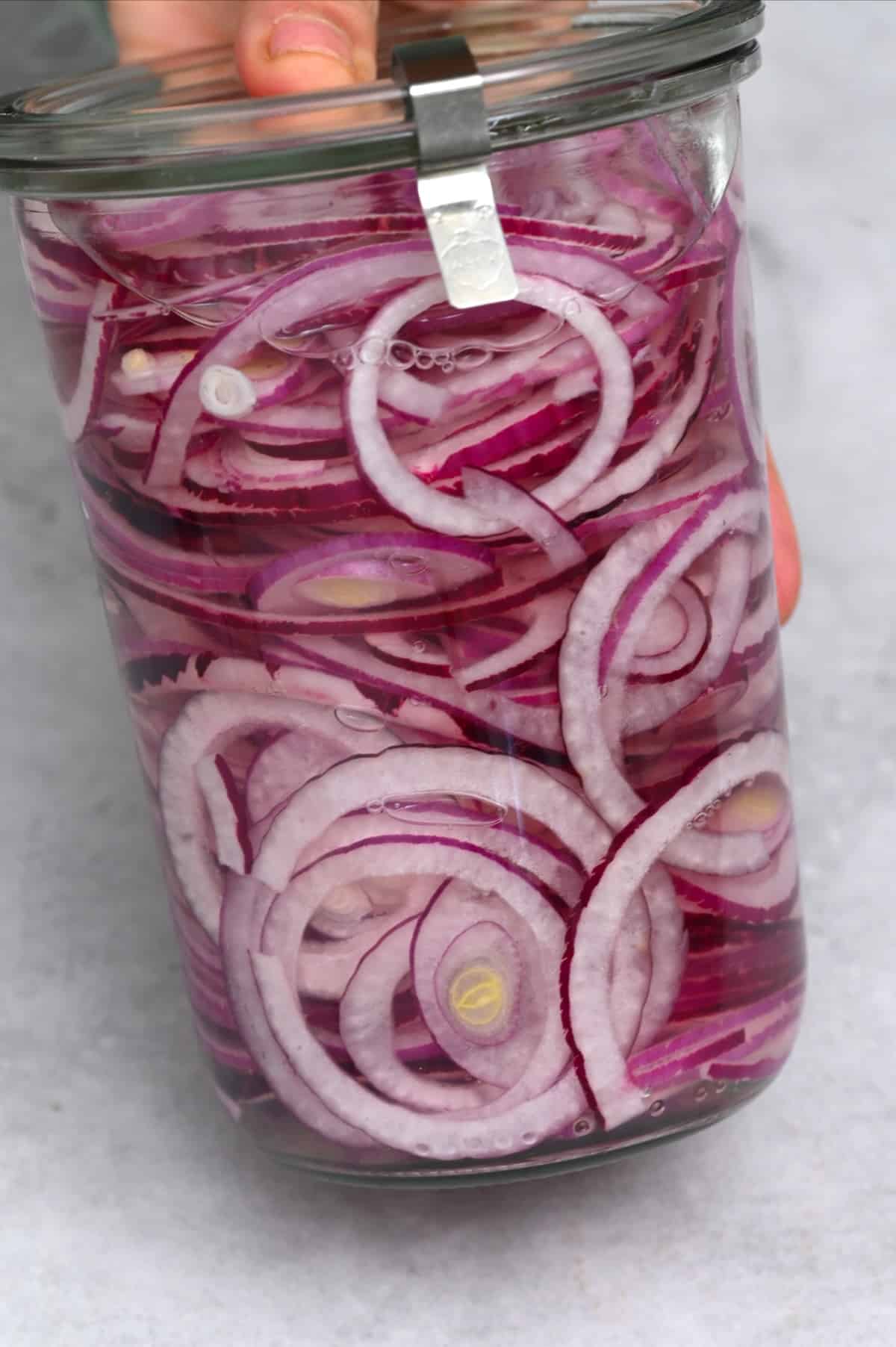 A jar with red onions and brine