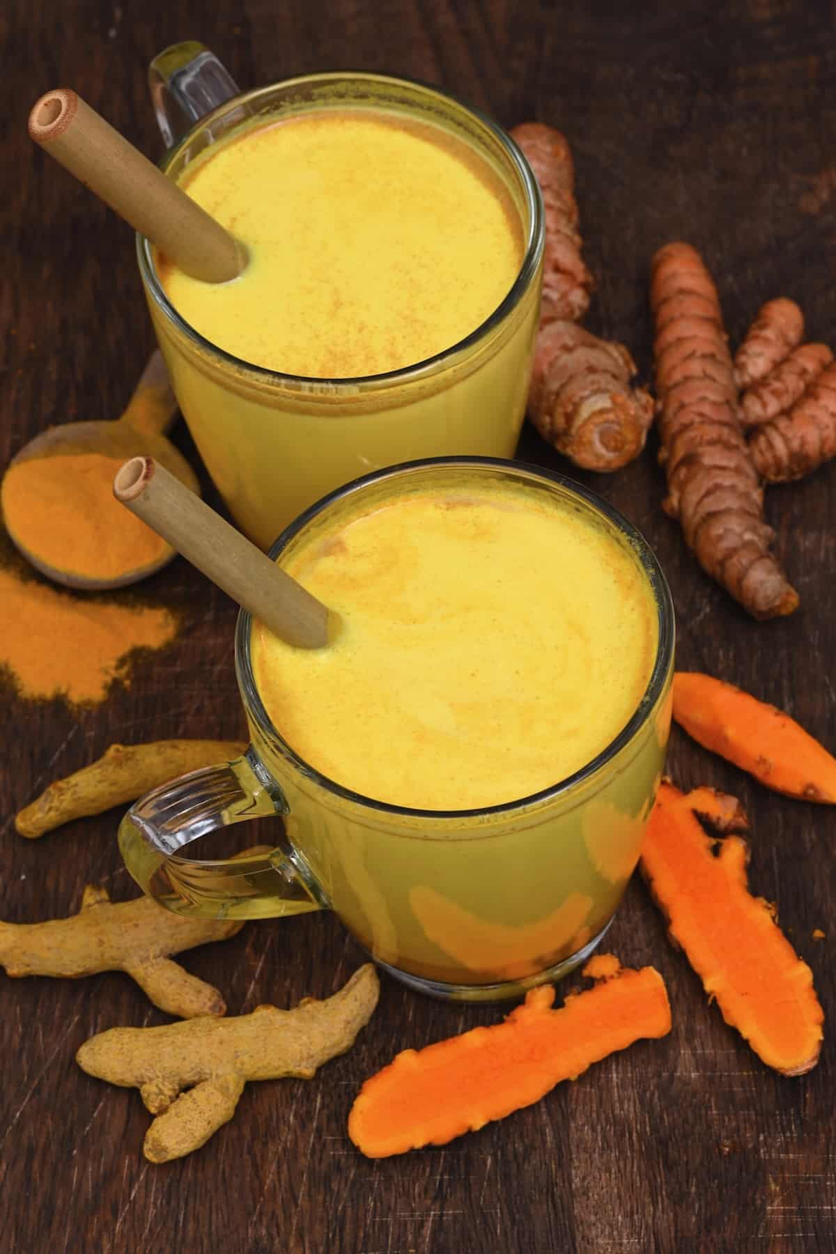 Two glasses with turmeric milk to showcase 30+ turmeric recipes