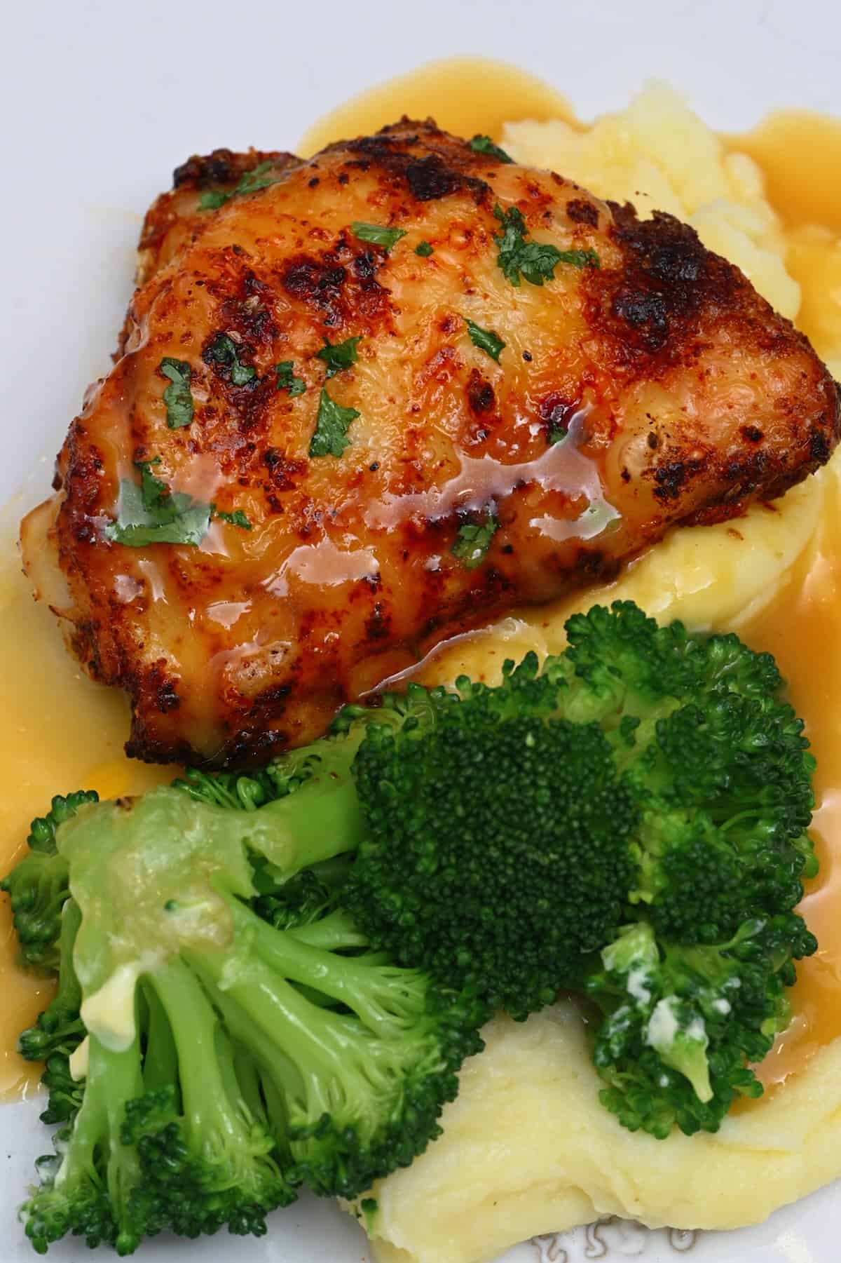 A serving of air fried chicken thighs with broccoli