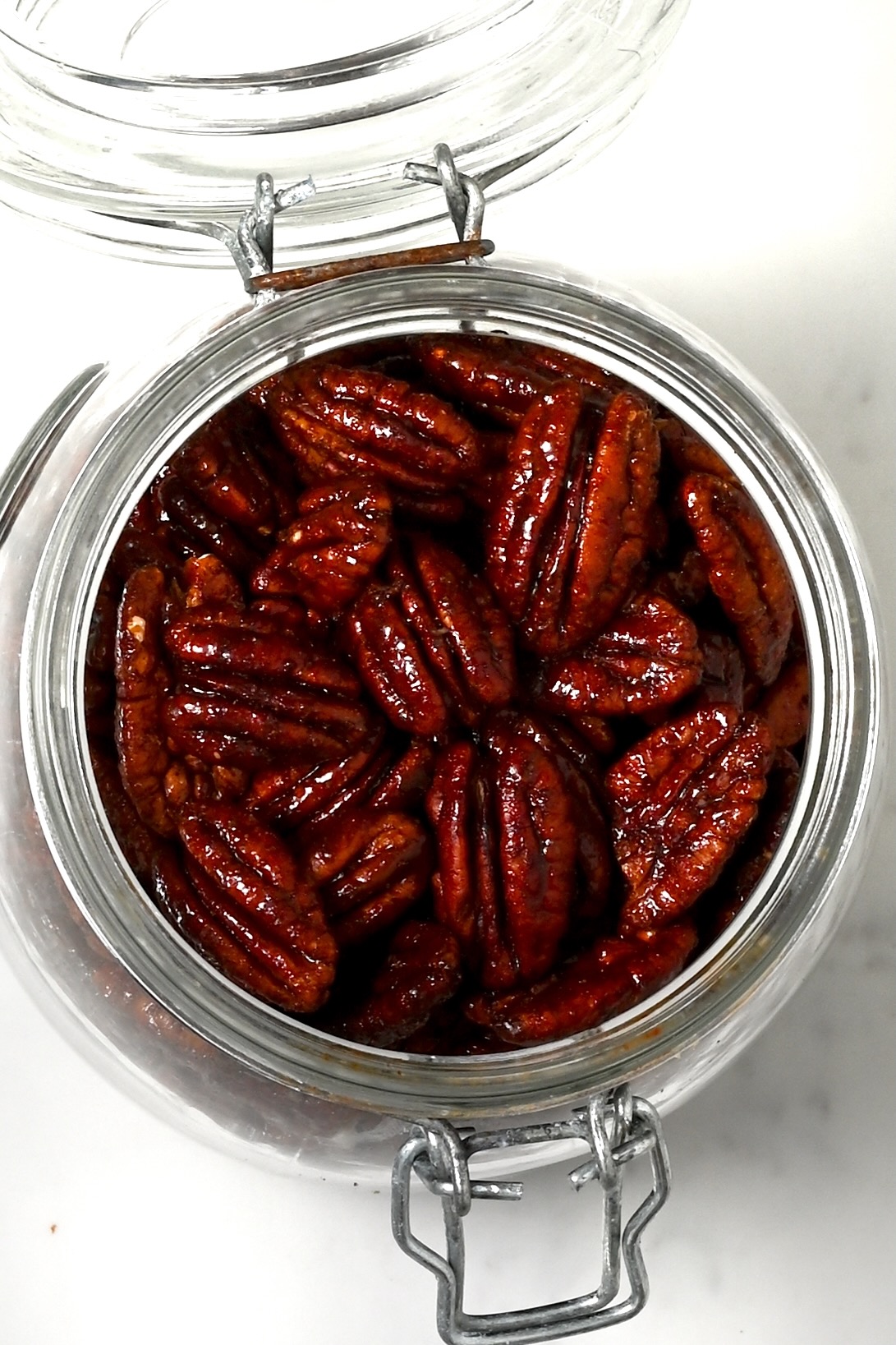 A jar filled with homemade candied pecans
