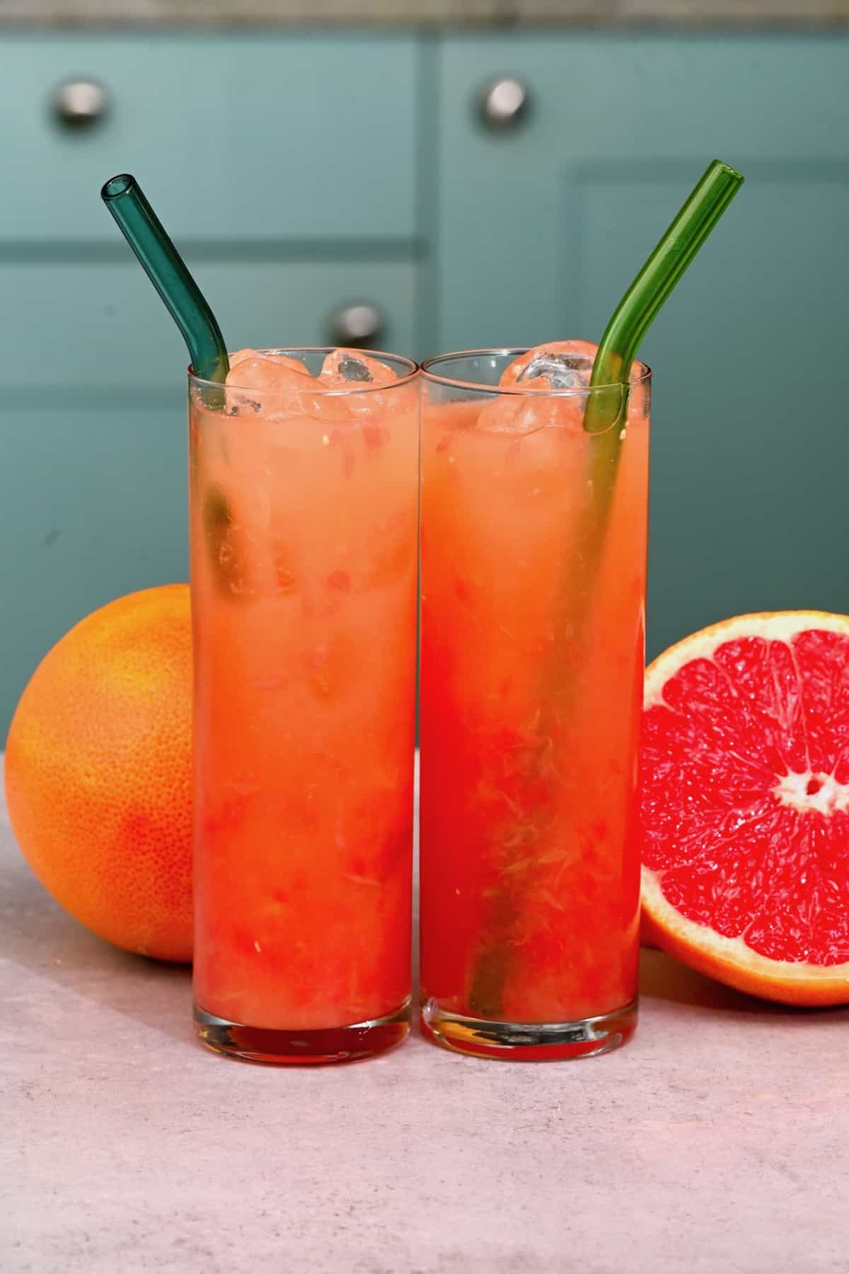 Two glasses with grapefruit juice and ice