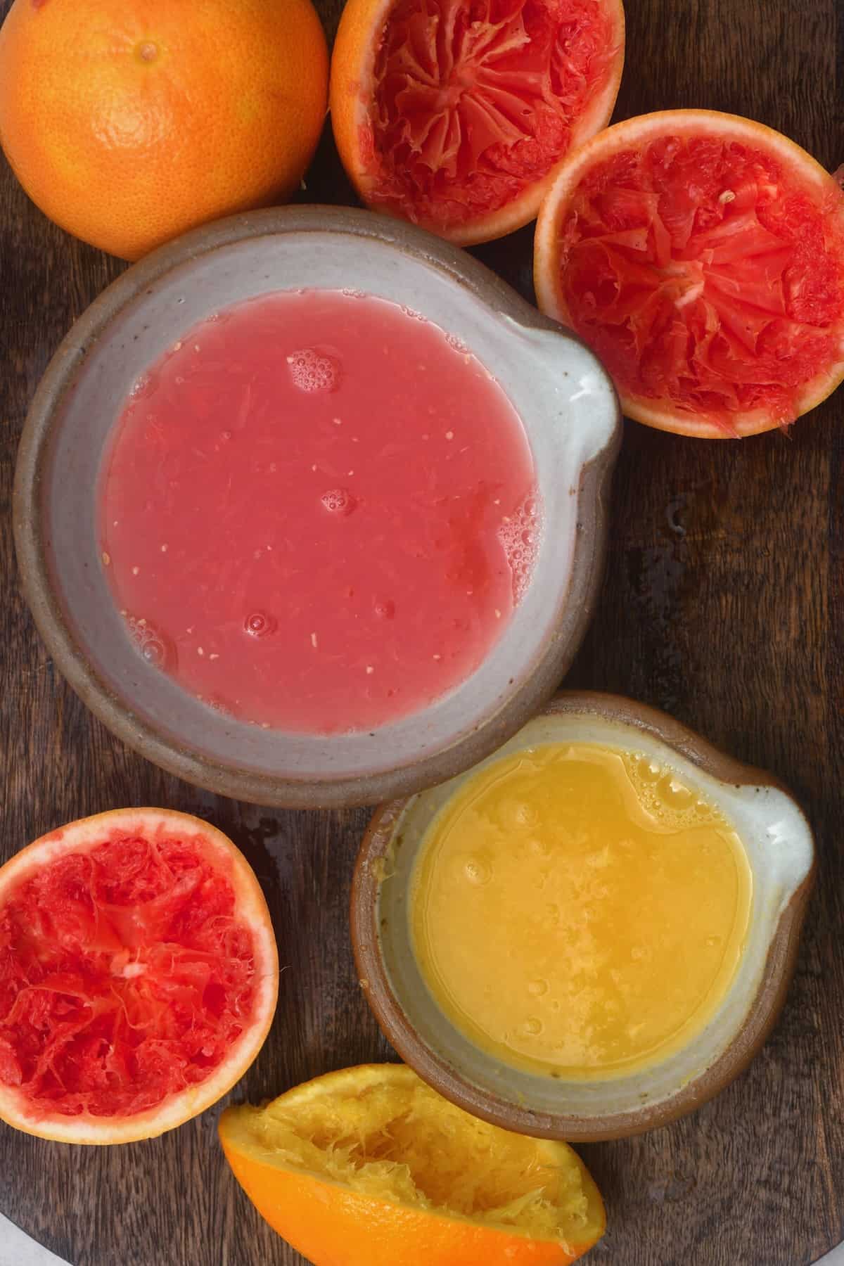 Two bowls with grapefruit and orange juice