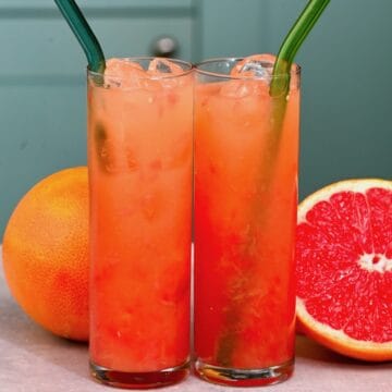 Two glasses with grapefruit juice and ice