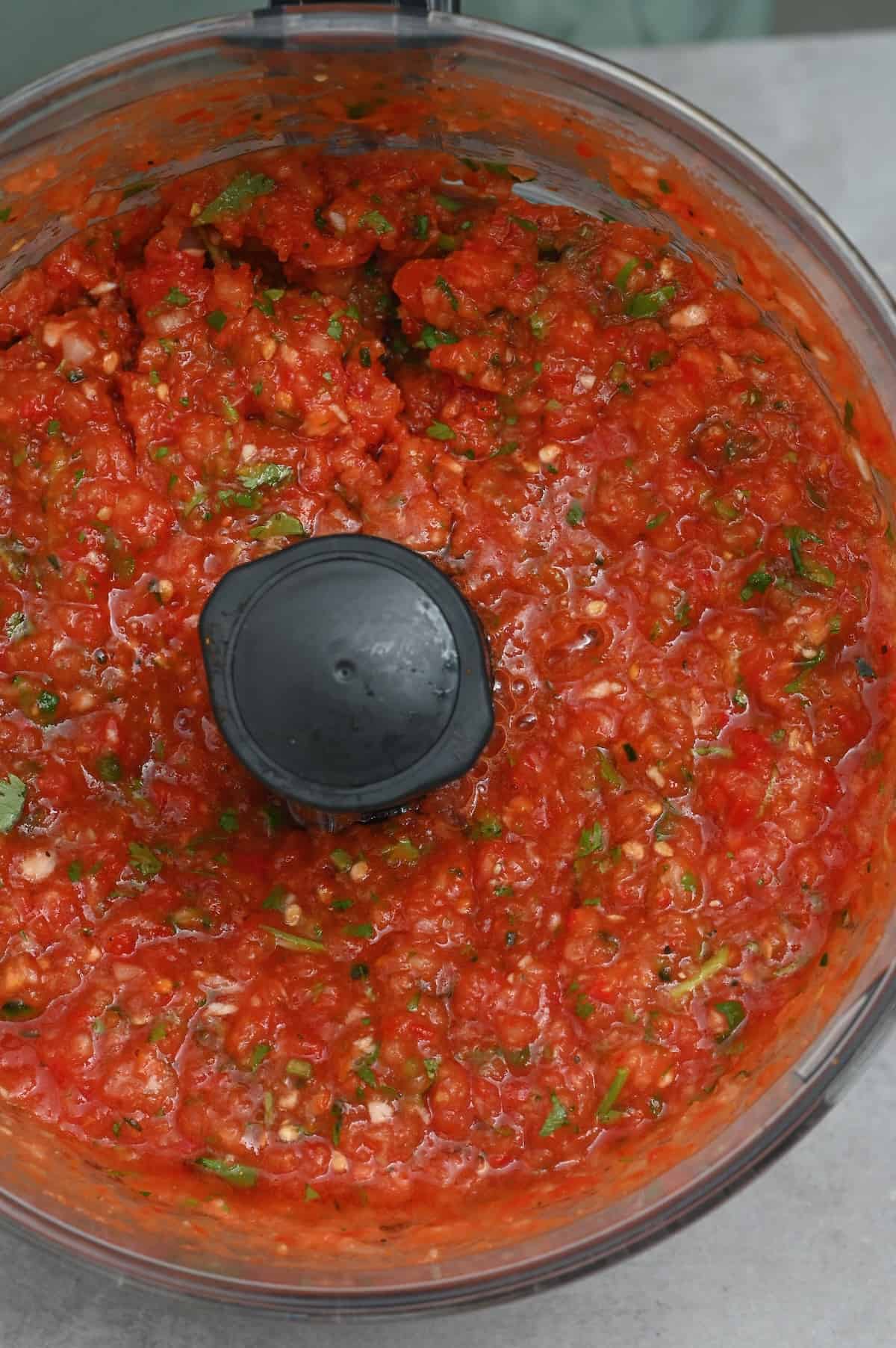 Homemade tomato salsa in a food processor