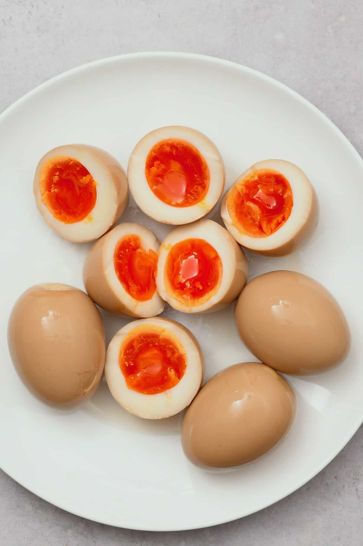 Six ramen eggs, three of them cut in half