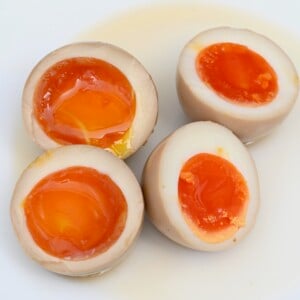 Two ramen eggs with jammy yolks cut in half