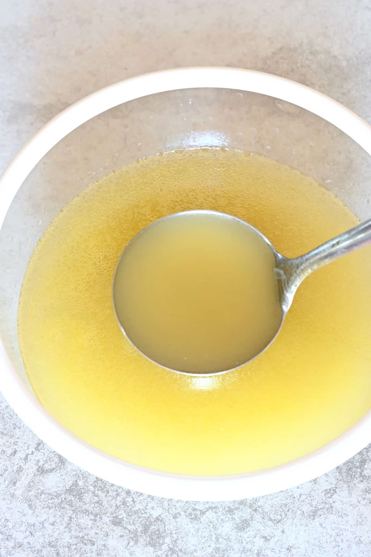 Homemade chicken broth in a bowl