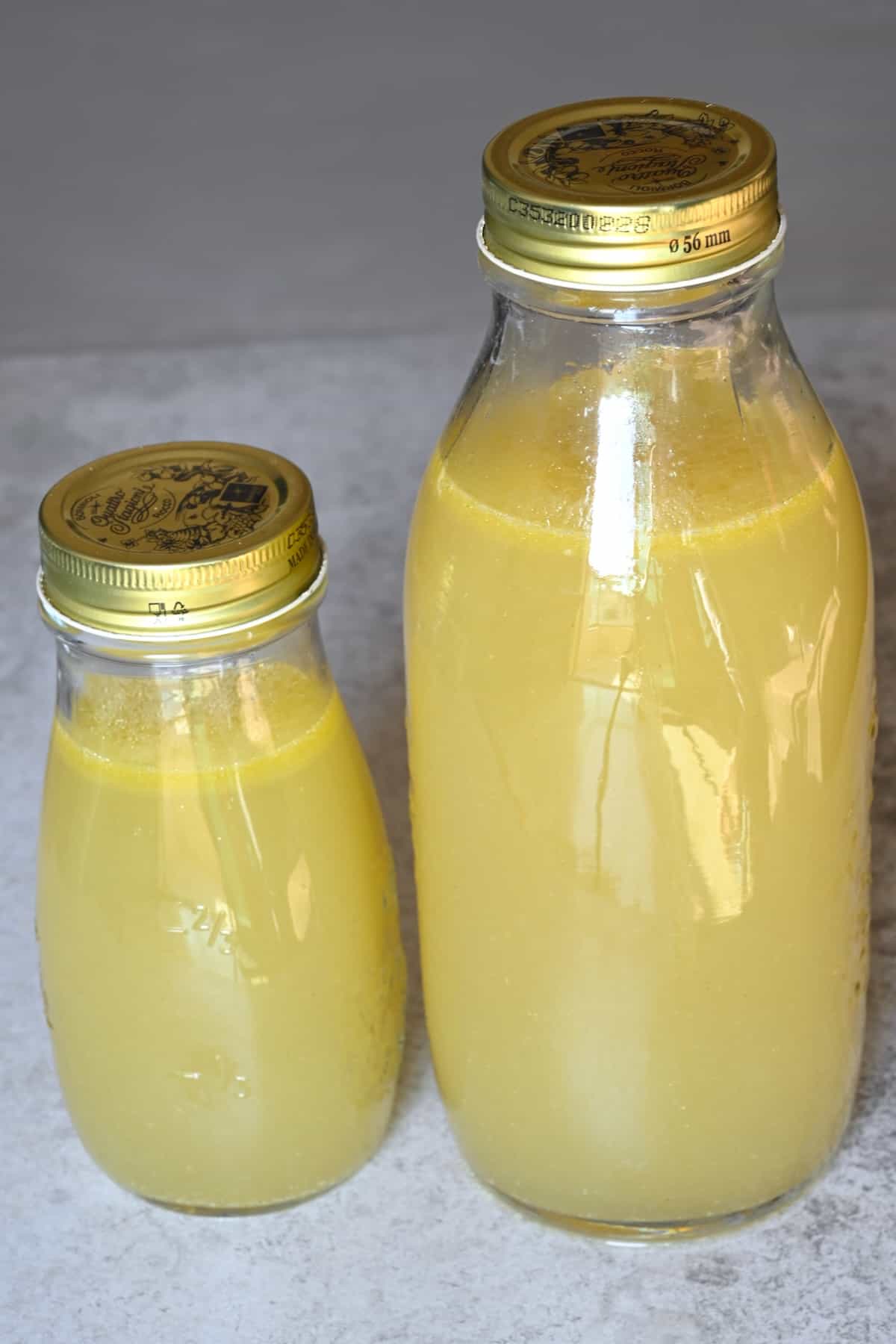 Two bottles with homemade chicken broth