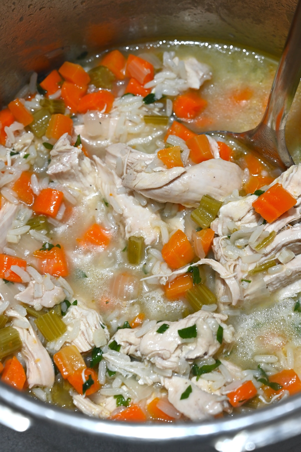 A pot filled with chicken and rice soup