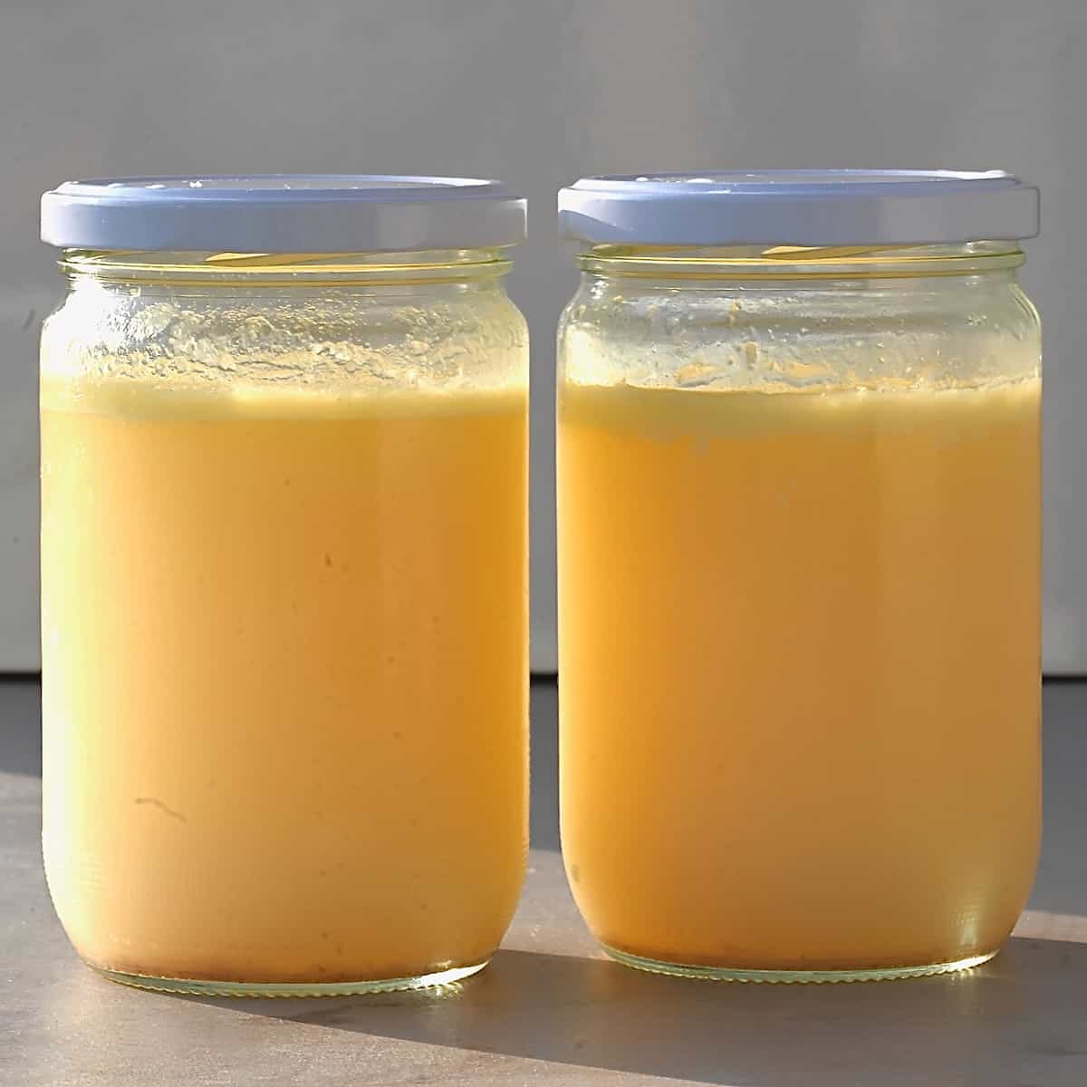 Two jars with homemade chicken stock