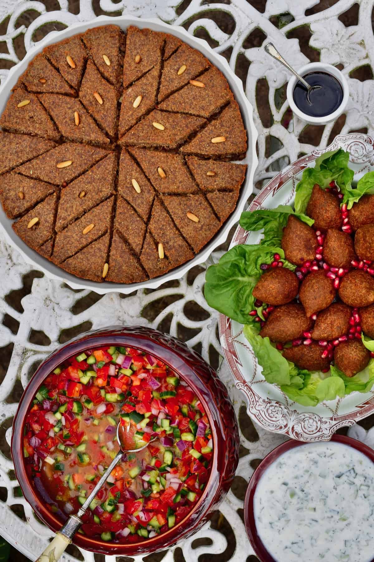 Fried and baked kibbeh next to salads