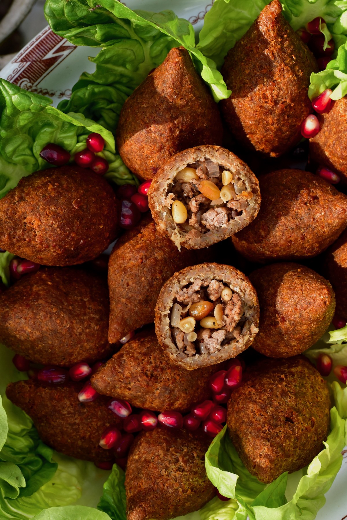 Homemade fried kibbeh topped with pomegranate seeds