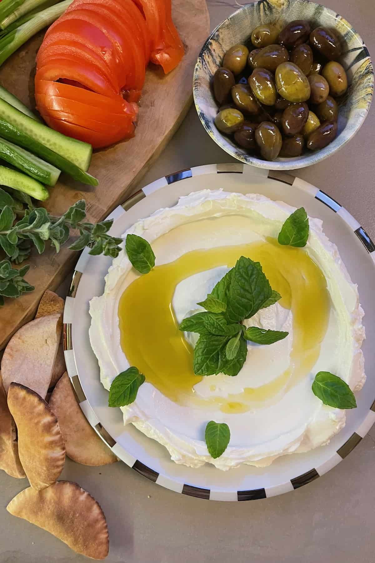 Homemade labneh topped with olive oil and mint leaves