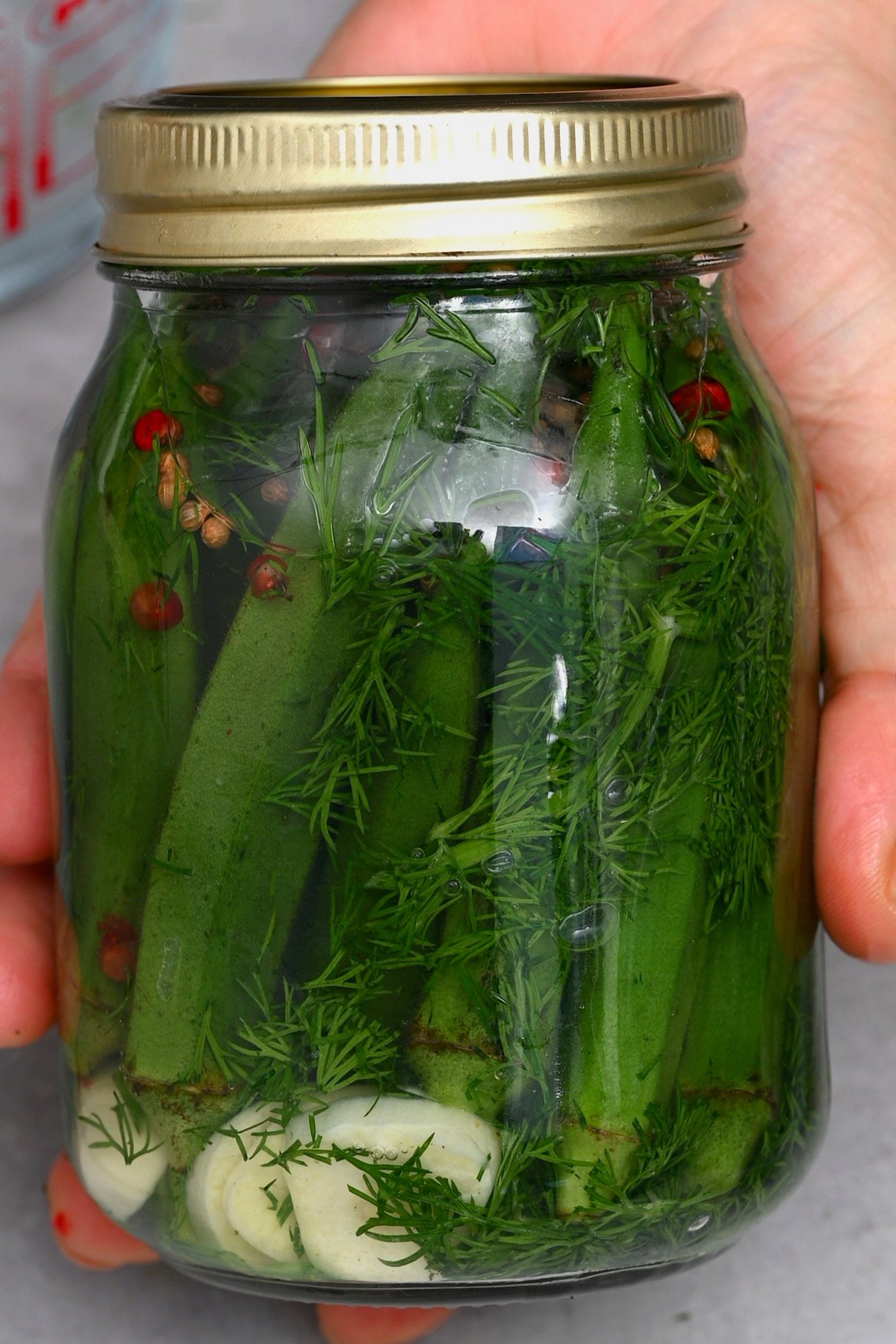 A jar with freshly made okra pickles