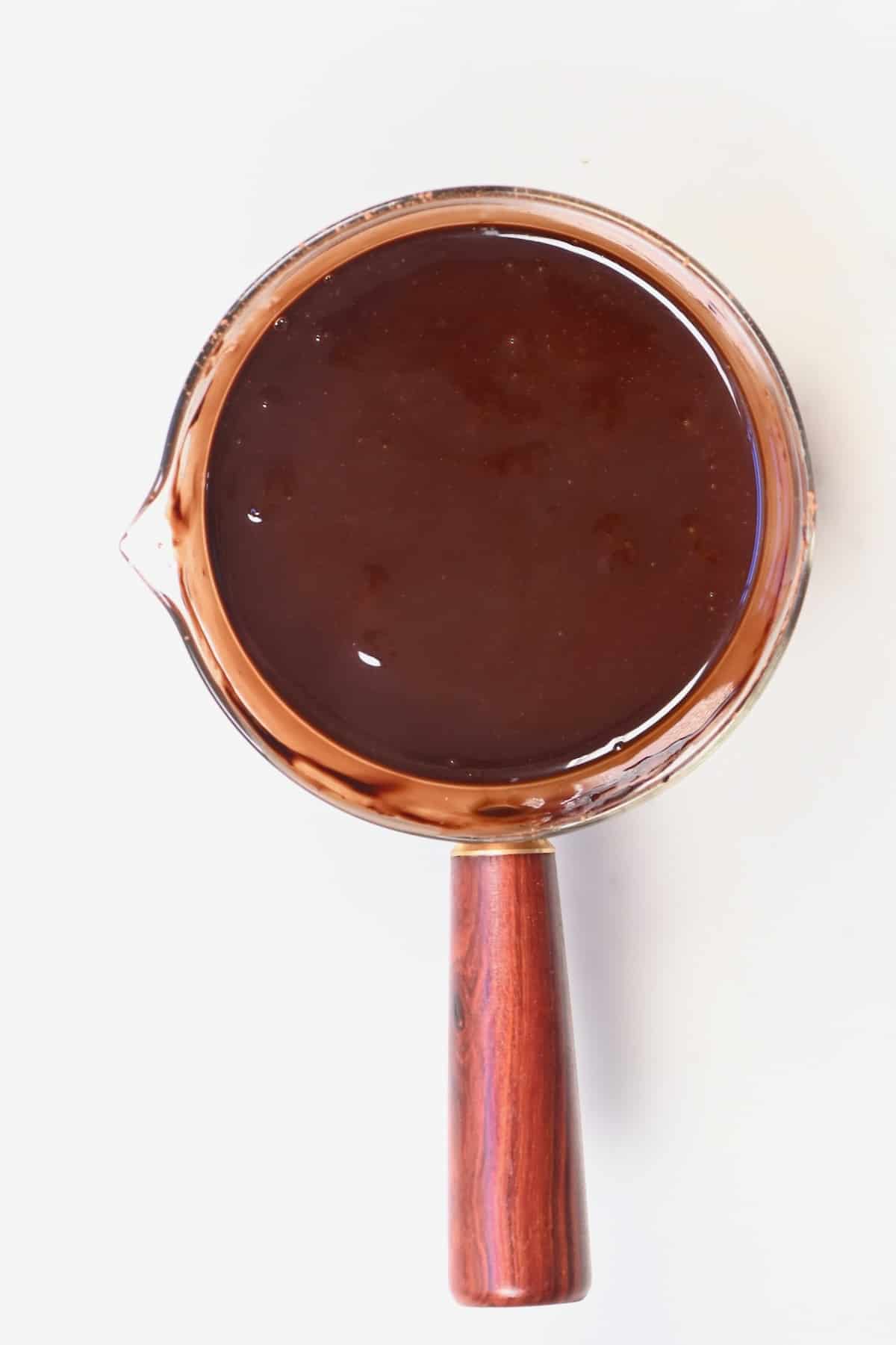 A small pot with homemade chocolate syrup