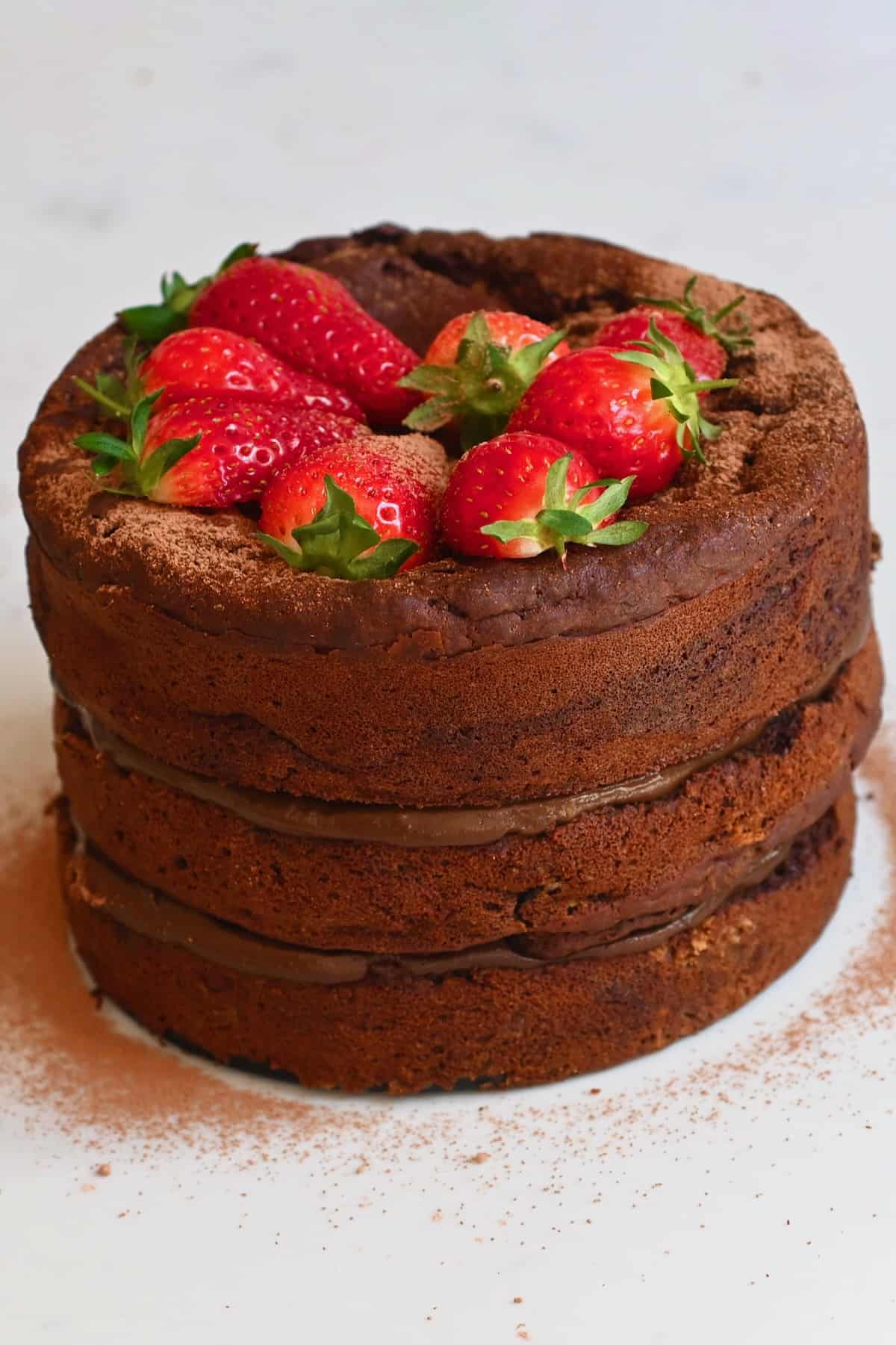 Chocolate zucchini cake topped with strawberries