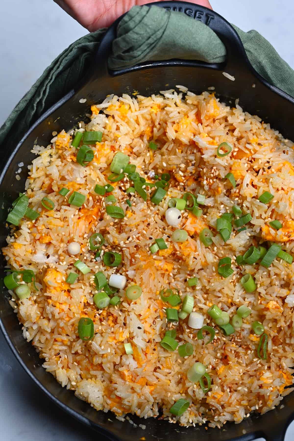 Egg fried rice topped with scallions and sesame seeds