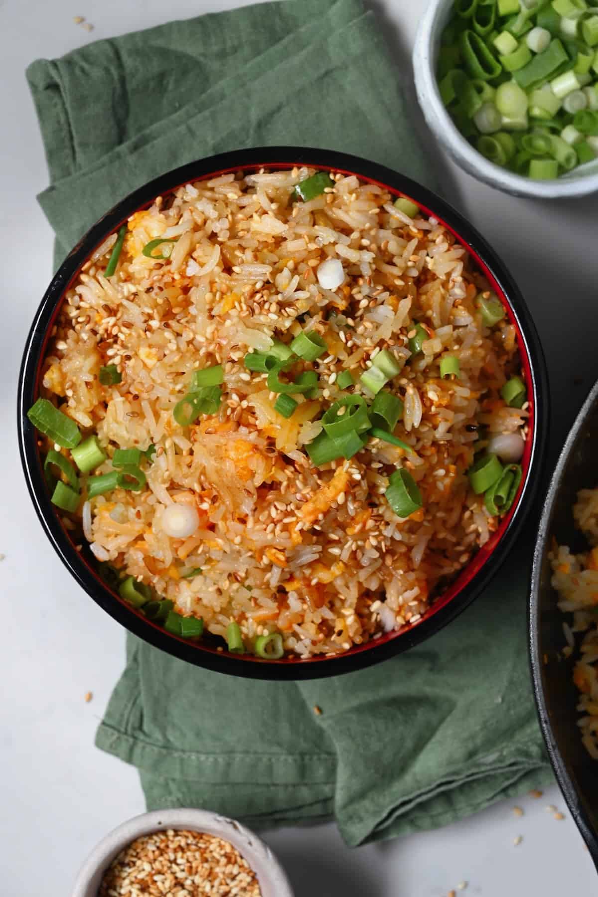 A serving of egg fried rice topped with scallions and sesame sees